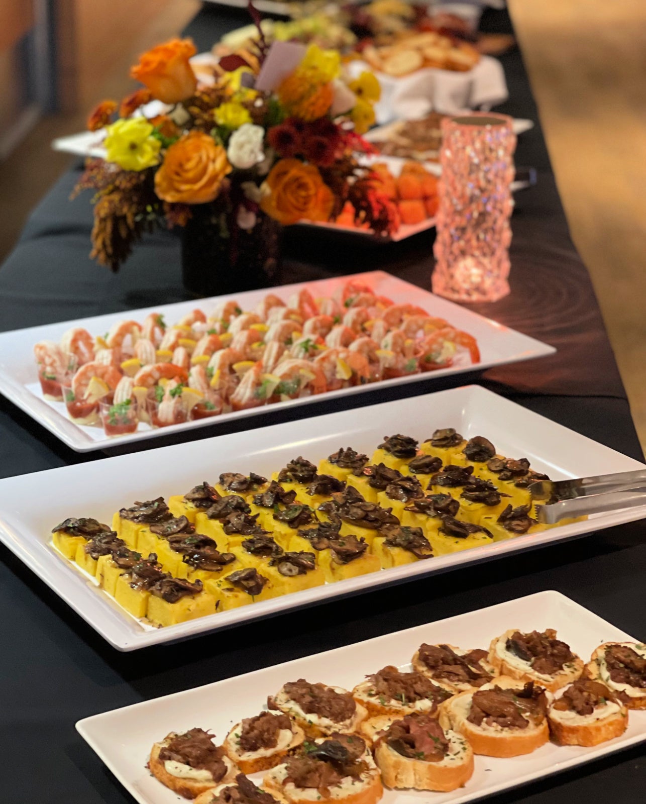 Shef Madres catering a wedding event with appetizer platters displayed on table setting