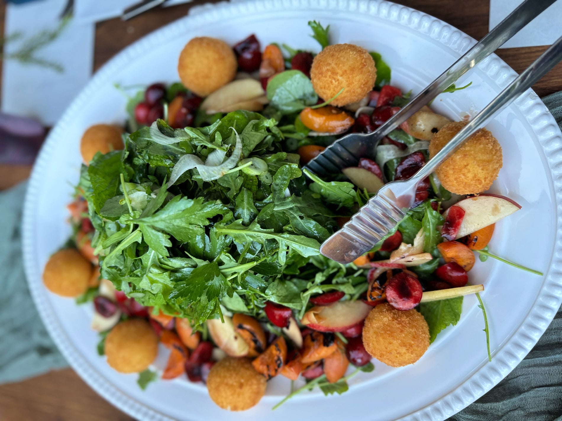 Shef Madres Catering fresh herb arugula salad with stone fruit and goat cheese