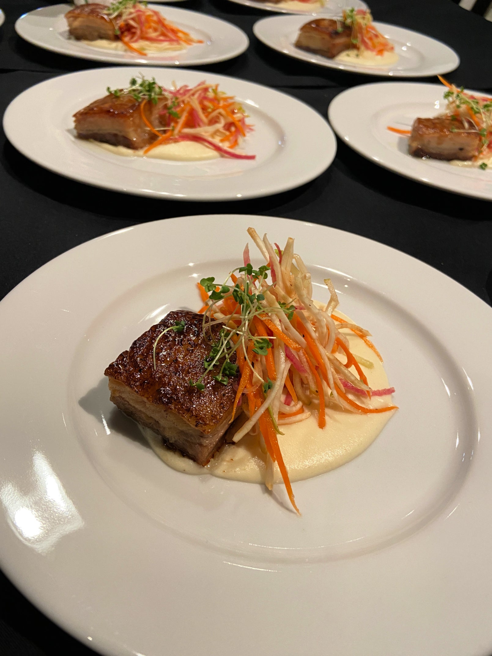 Shef Madres Catering pork belly served with carrot slaw.